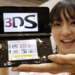 Model poses with Nintendo Co Ltd’s new 3DS handheld game console in Chiba